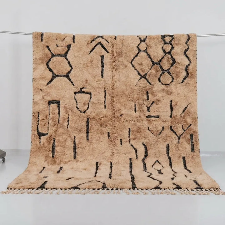 Tribal Treasures Custom Moroccan Rug Beni Mrirt - Hand-knotted beige wool rug with black abstract tribal symbols and high pile texture
