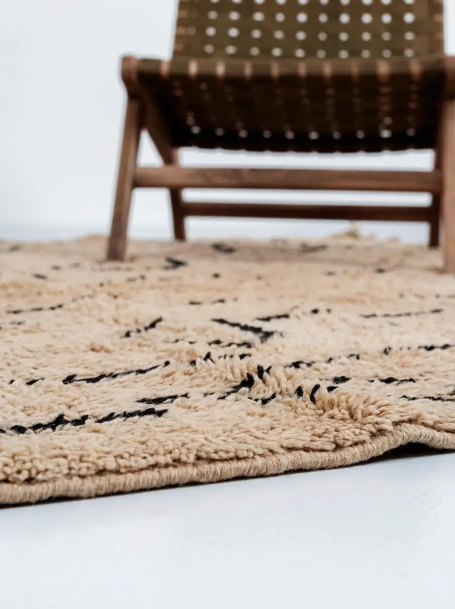 Tribal Treasures Custom Moroccan Rug Beni Mrirt - Hand-knotted beige wool rug with black abstract tribal symbols and high pile texture