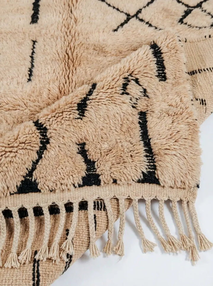 Tribal Treasures Custom Moroccan Rug Beni Mrirt - Hand-knotted beige wool rug with black abstract tribal symbols and high pile texture